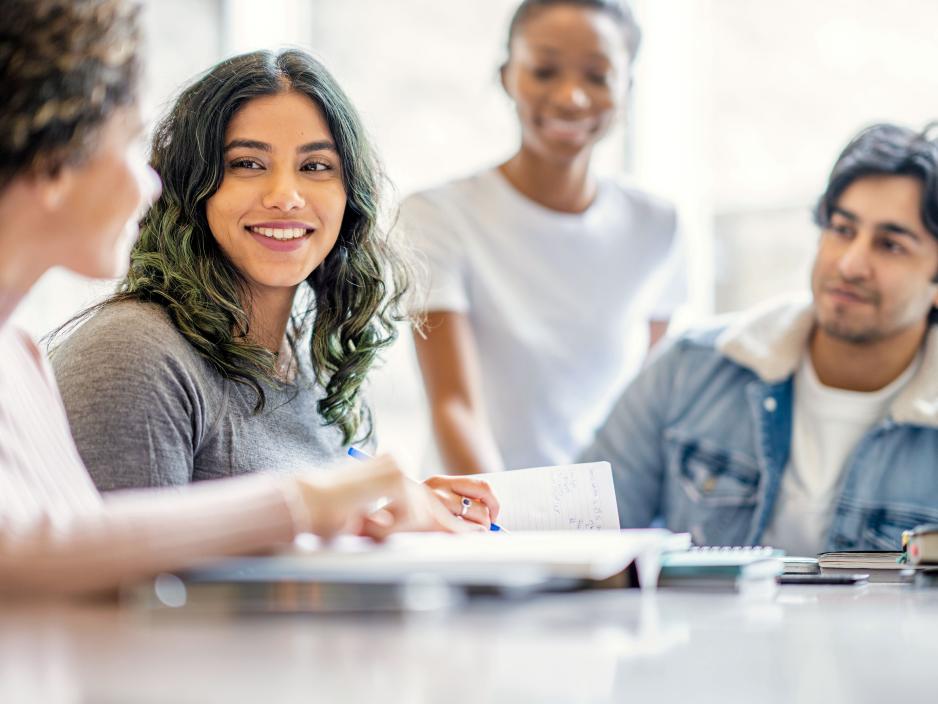 College students in a classroom working on a group task.